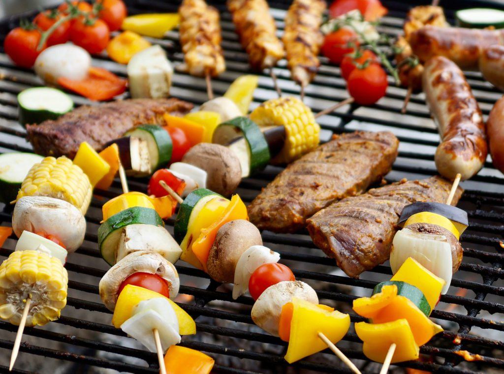 shish kabobs on a gas grill grate