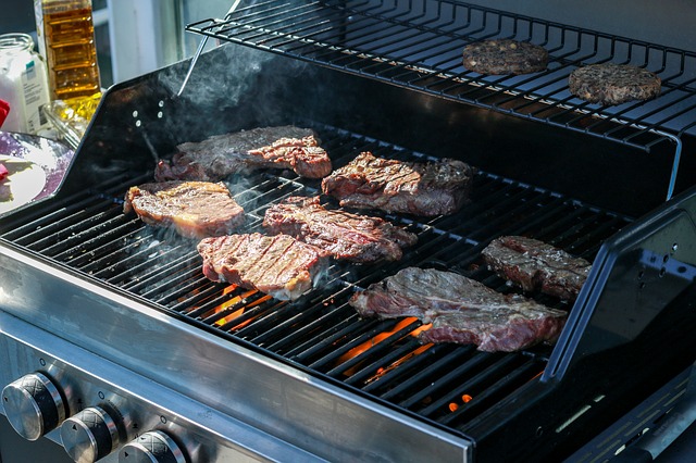 gas grill filled with meat