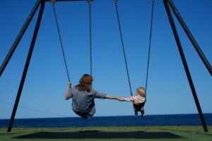 Mom and daughter swinging