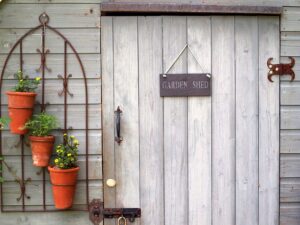 wooden shed with door sign saying "garden shed"