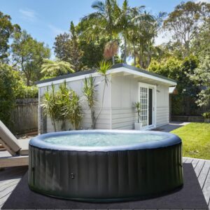 inflatable hot tub on a felt mat, on a deck