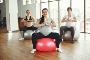 pregnant women bouncing on exercise balls